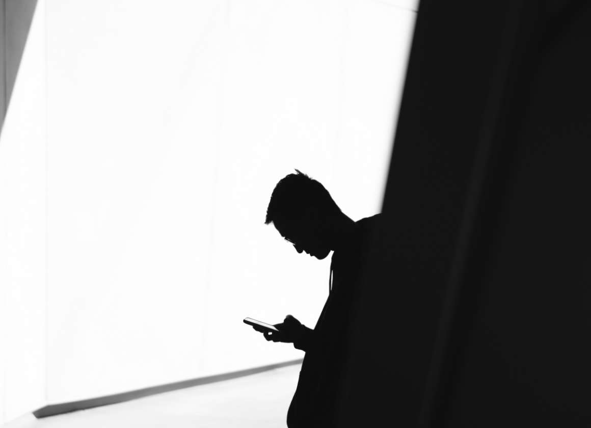 Une image sur une page Web concernant le site Web sur la santé mentale de Jeunesse, J'écoute d’une jeune personne se tenant debout et regardant un téléphone